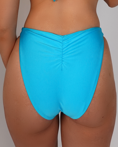 Back of womens blue swimwear bottom. Mid-cheeky coverage.